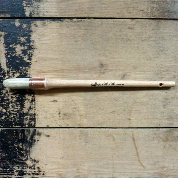 The Omega 203 Sash Brush features white hog bristles, a copper ferrule, and a long, untreated wood handle, making it uniquely suited to larger painting projects.